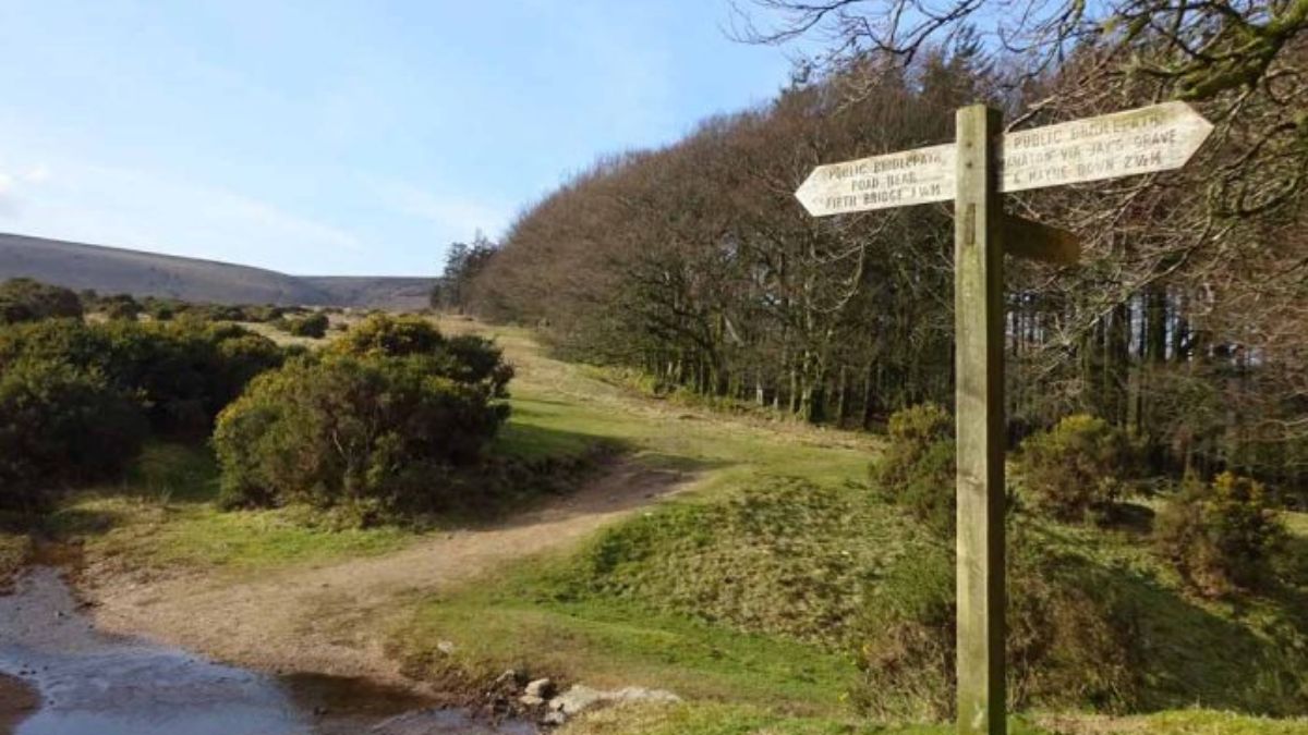 A signpost on Dartmoor indicating a walking route across the moor