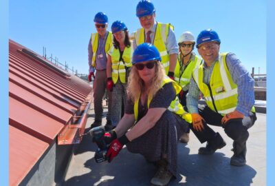 The Chair of Devon County Council, Councillor Caroline Leaver (front, centre) with local members and VIPs attending a topping-off ceremony of the new build GP surgery and community building