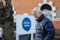 Happy man standing out side a Citizens Advice office