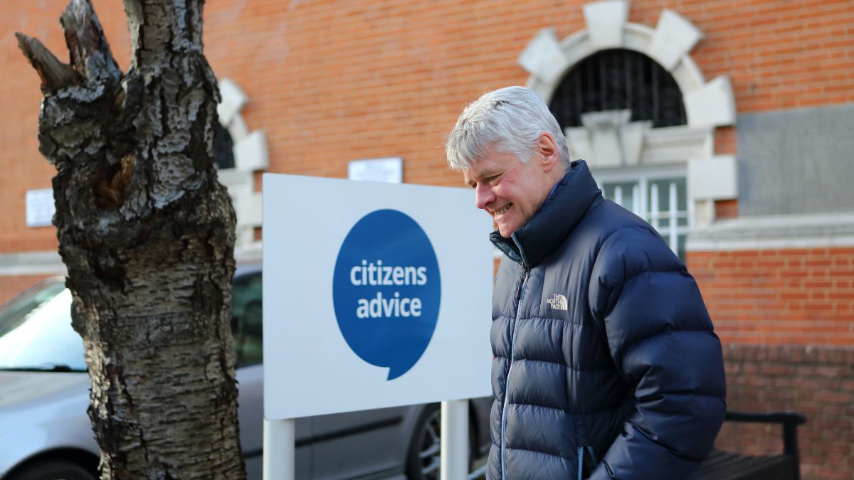 Happy man standing out side a Citizens Advice office