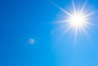 A bright sun in the blue sky