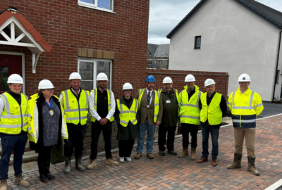Councillors gathered in front of a house at the development site of new affordable homes in North Devon.