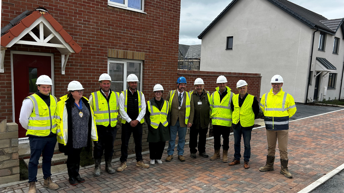 Councillors gathered in front of a house at the development site of new affordable homes in North Devon.