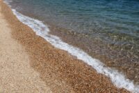 Gentle waves washing ashore on a pebbly beach
