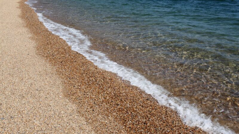 Gentle waves washing ashore on a pebbly beach