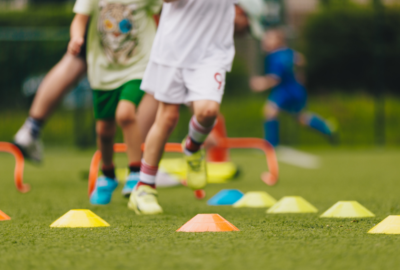 children learning football skills