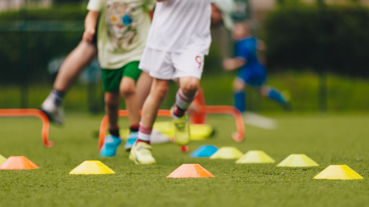 children learning football skills