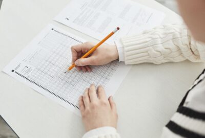 A student writing on an exam paper