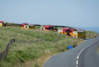 Three fire engines attending a wildfire call on moorland.