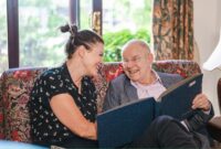 Man looking at a photo album with a carer
