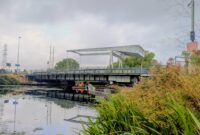 Specialist contractors in high-visibility clothing carry out inspections beneath the A379 Bridge Road bascule bridge over the Exeter Ship Canal.