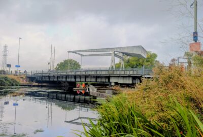 Specialist contractors in high-visibility clothing carry out inspections beneath the A379 Bridge Road bascule bridge over the Exeter Ship Canal.