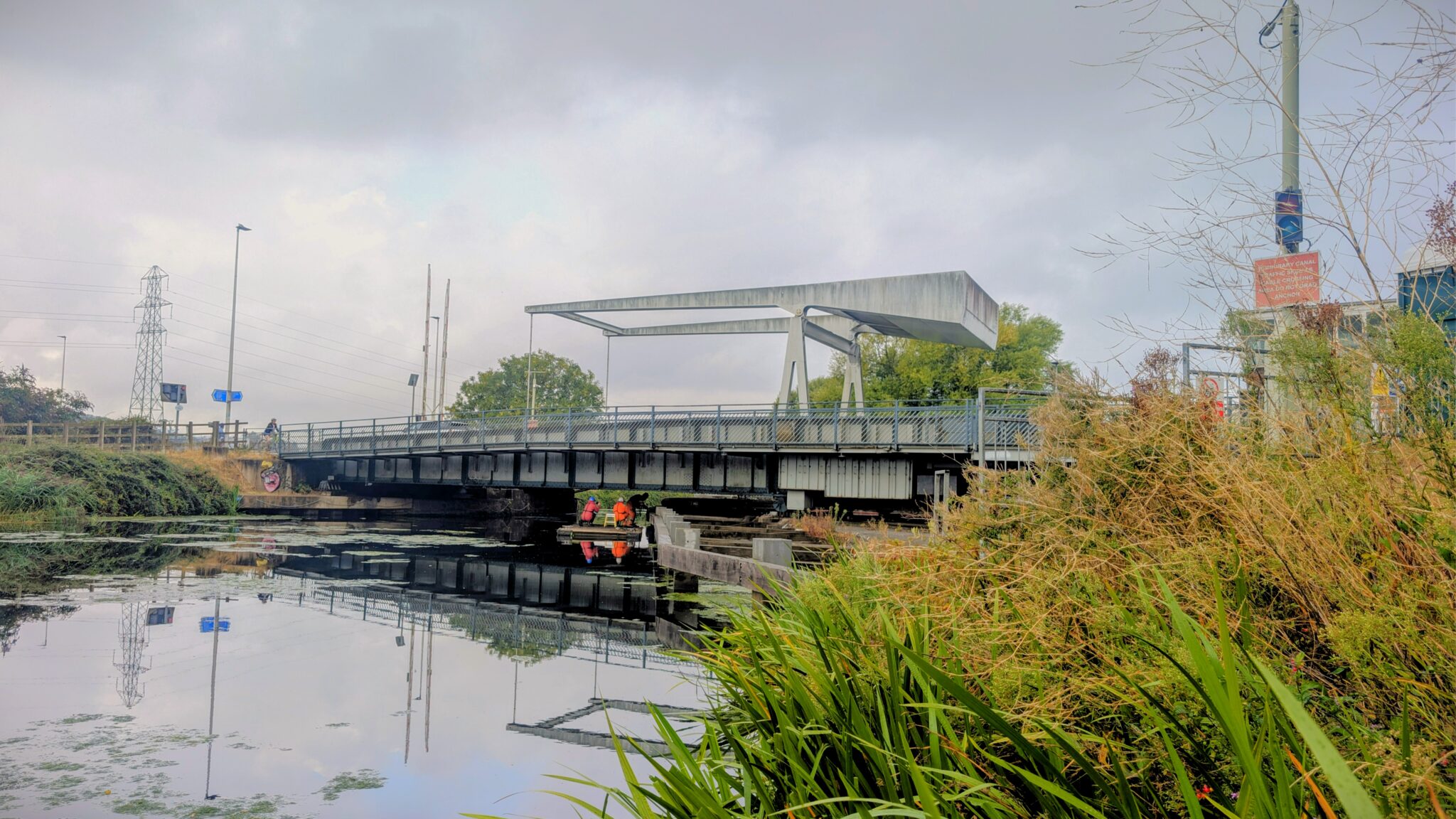 Specialist contractors in high-visibility clothing carry out inspections beneath the A379 Bridge Road bascule bridge over the Exeter Ship Canal.