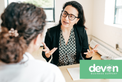 Small business owner standing in a workplace, representing support available to businesses and entrepreneurs in Devon.