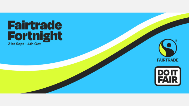 Fairtrade Fortnight promotional graphic with a bright blue background and curved white, lime green and black bands sweeping across the image. Text reads “Fairtrade Fortnight, 21st Sept – 4th Oct”. The Fairtrade logo and “Do It Fair” campaign logo appear on the right-hand side.