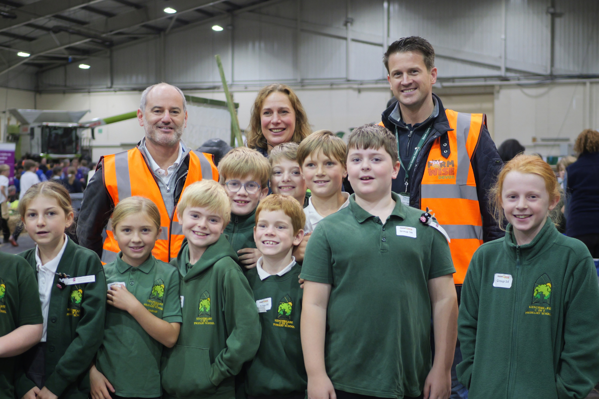 Photo of Matthew Jones, Bev Brown, Sam Fraser, and a number of school children from Alphington Primary School at this year's Farmwise Devon, Westpoint