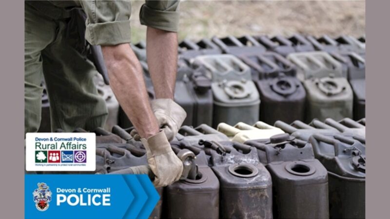 A person filling up jerry cans with fuel, with gloved hands and sleeves rolled up