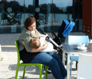Mother breastfeeding at a cafe