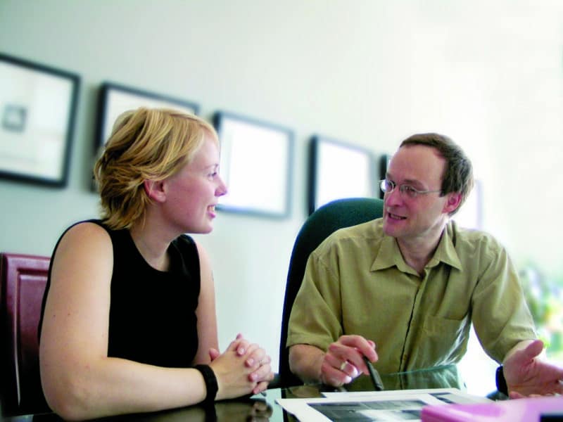 Woman and man discussing financial plans.