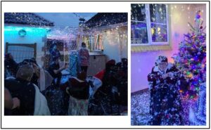 A girl in a wheelchair next to a Christmas tree. People outside celebrating Christmas.