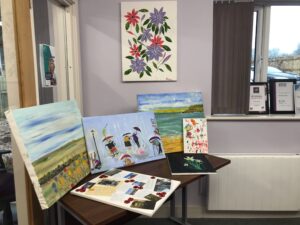 A selection of paintings on a table.