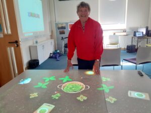 Client standing next to an interactive table.