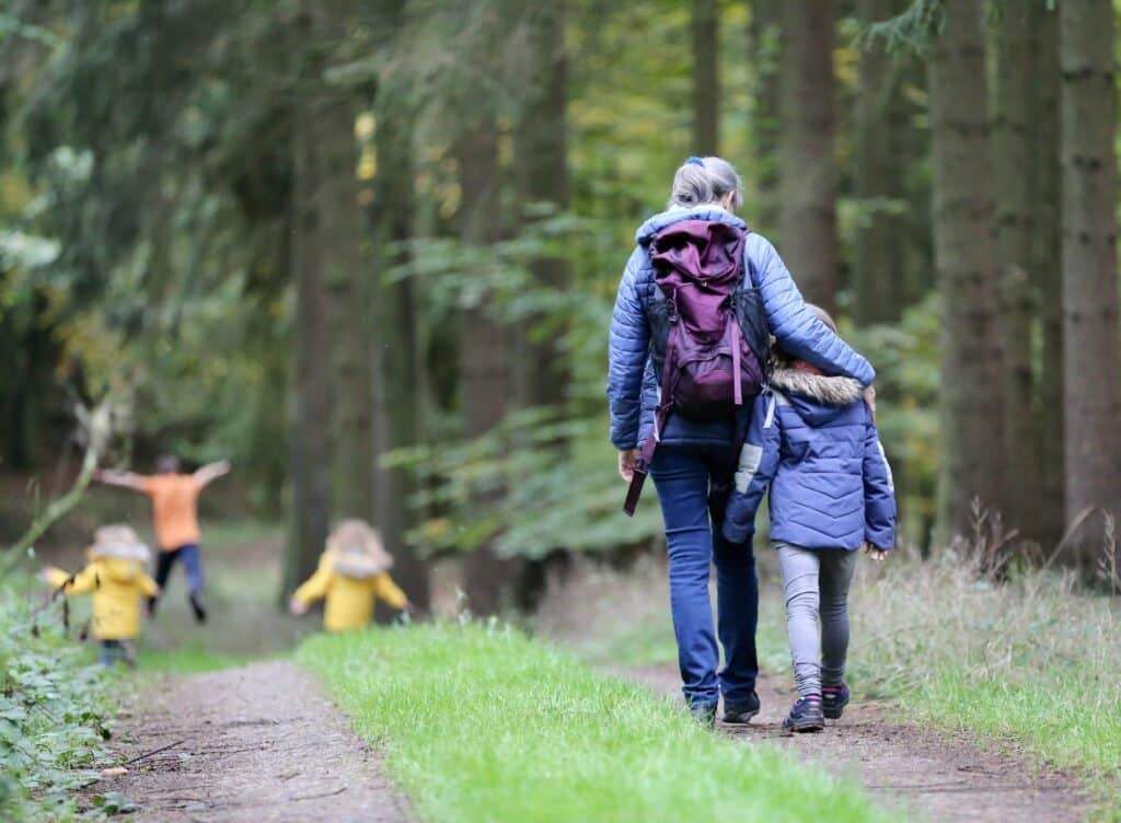 Photo of family walking in woods by Juliane Liebermann on Unsplash
