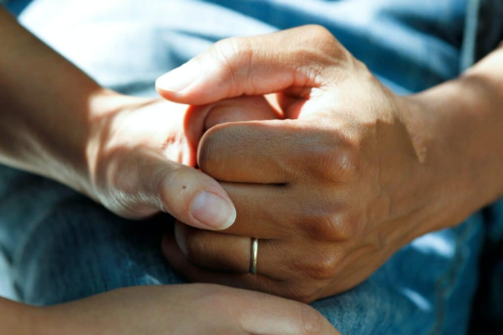 Photo of holding hands by National Cancer Institute on Unsplash