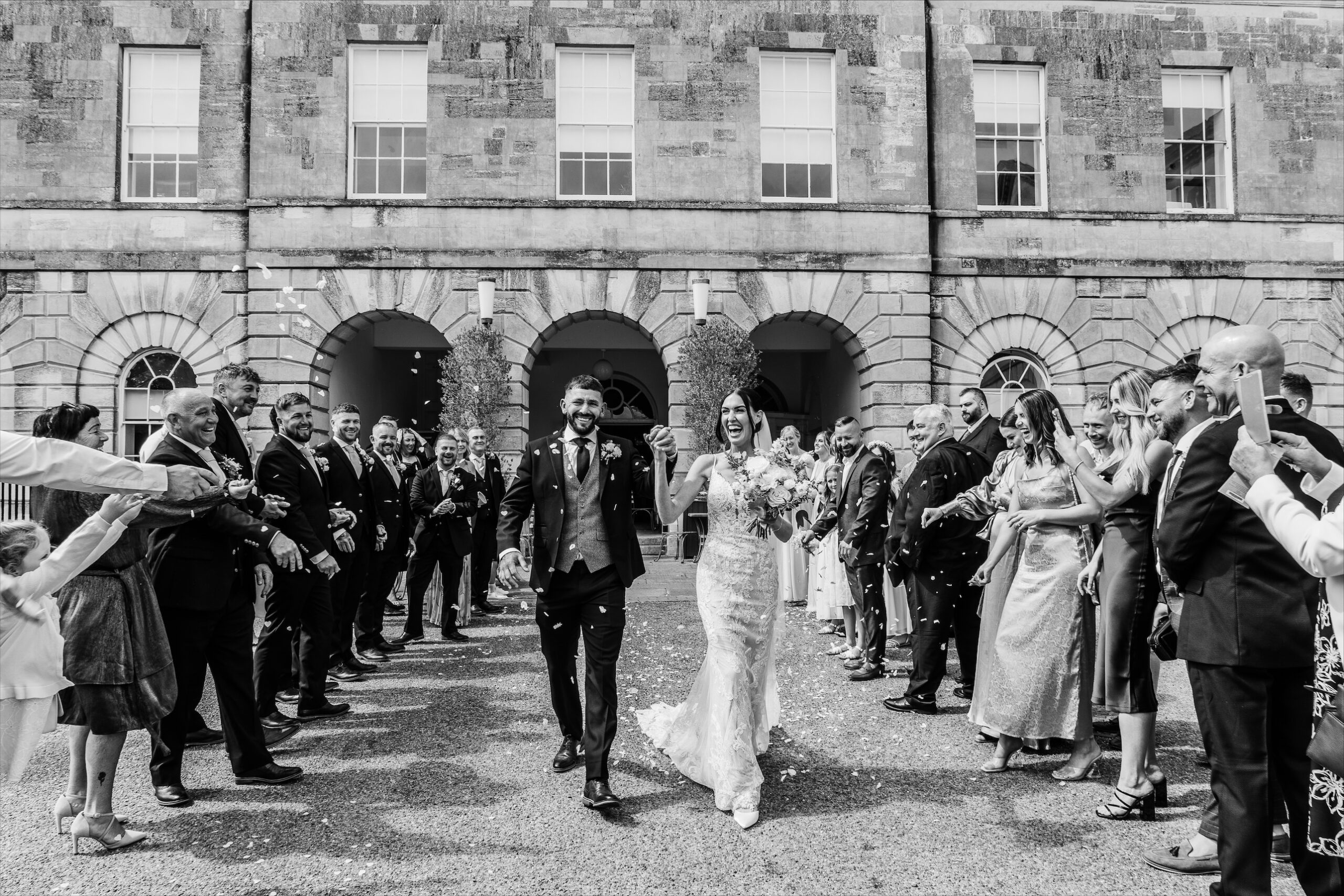 Bride, groom and wedding guests at Exeter Castle