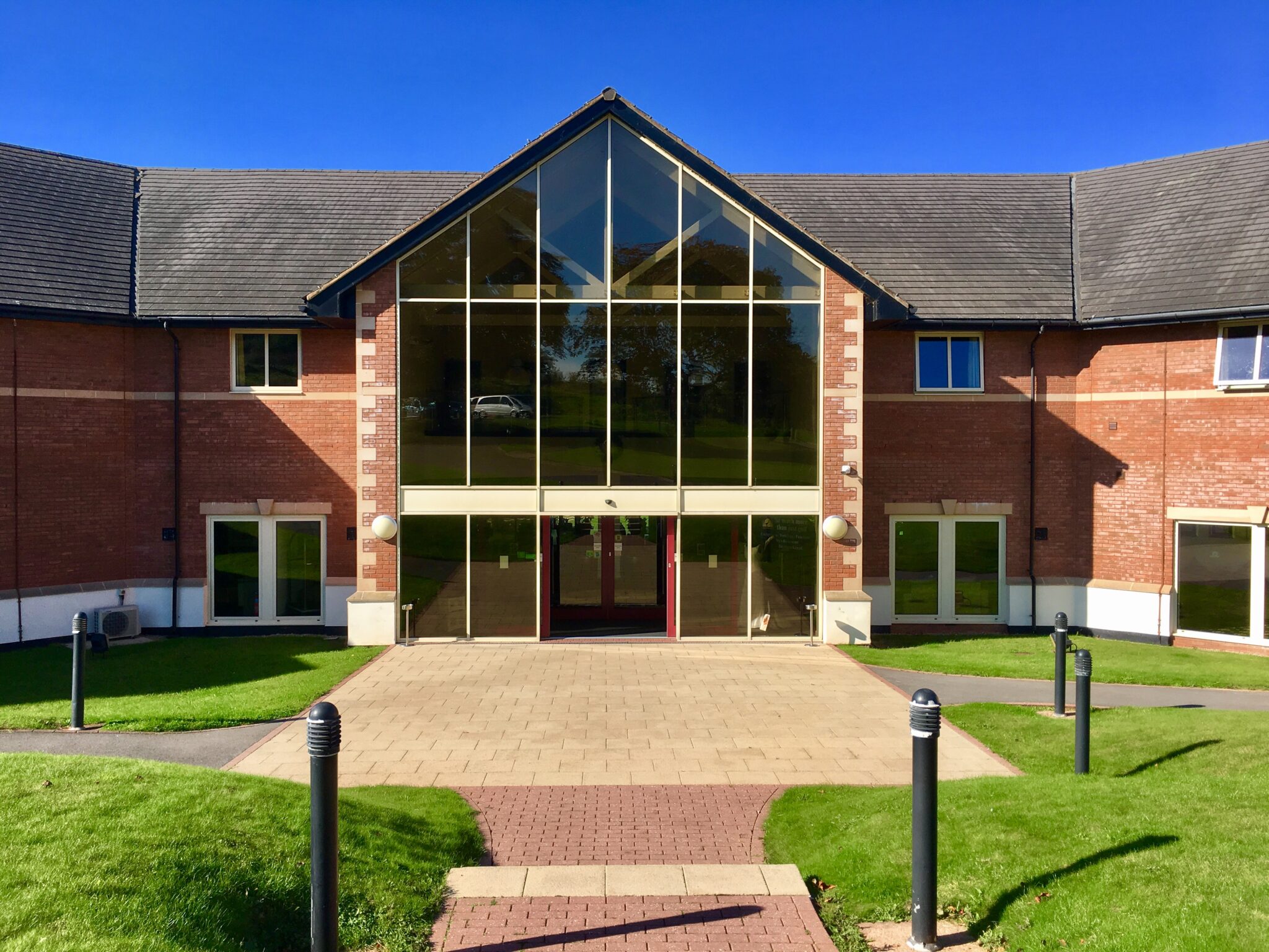 A brick building with a glass fronted entrance area