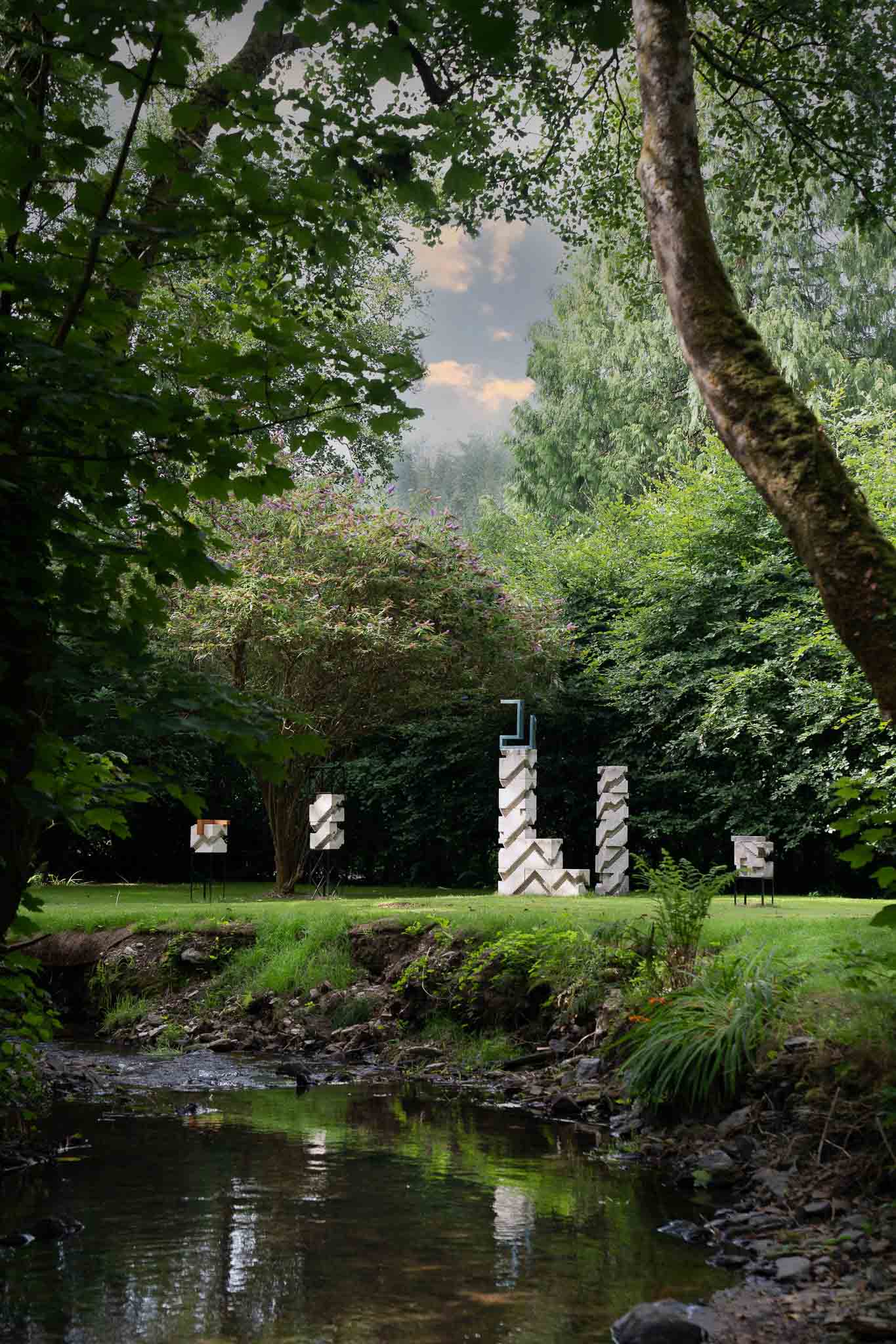 Sculptures in the garden, next to a stream