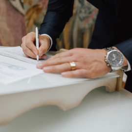 man signing document