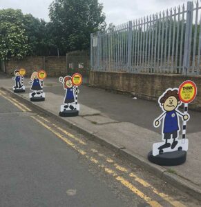Road Safety Parking Buddies Pavement Sign with Lollipop Message on footway near a school