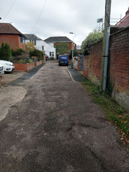 Image shows uneven road surface 