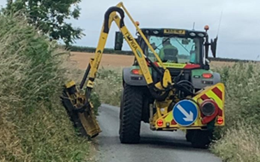 photo of a tractor with a flair mower