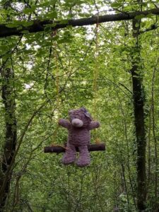 A bear swinging from the trees