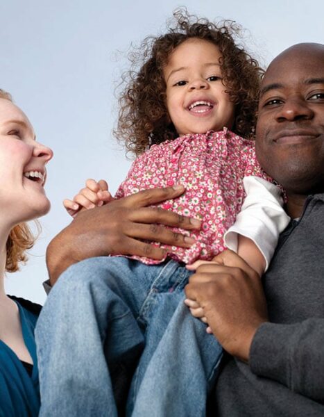 A mother and father with their young daughter