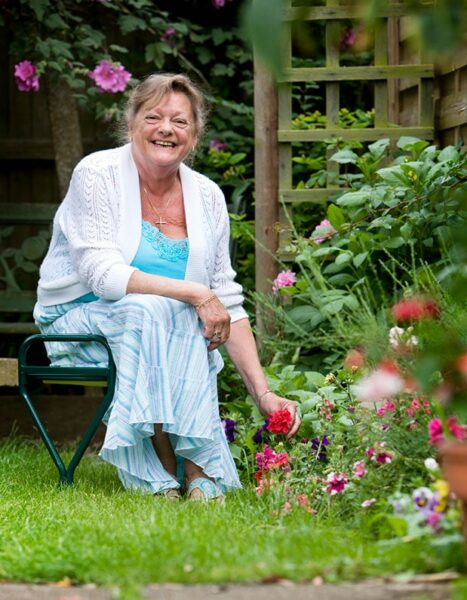 A smiling lady in her garden