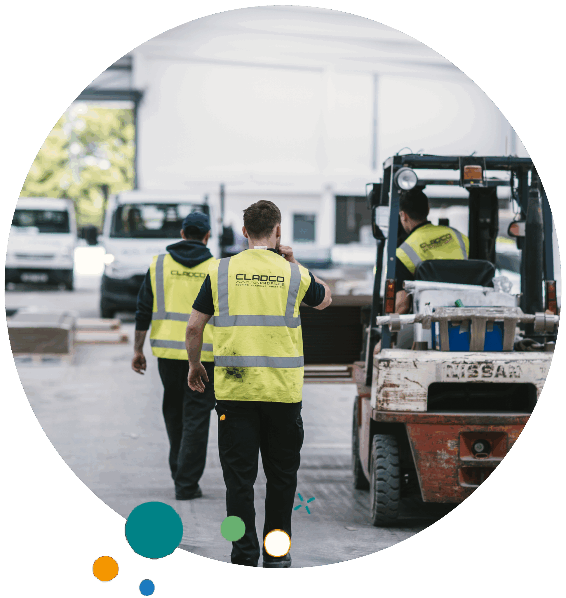 warehouse workers wearing yellow safety vests with 'Cladco' branding, one walking while another operates a forklift to move materials