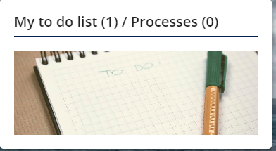A notepad with the words to do written on it, and a pen