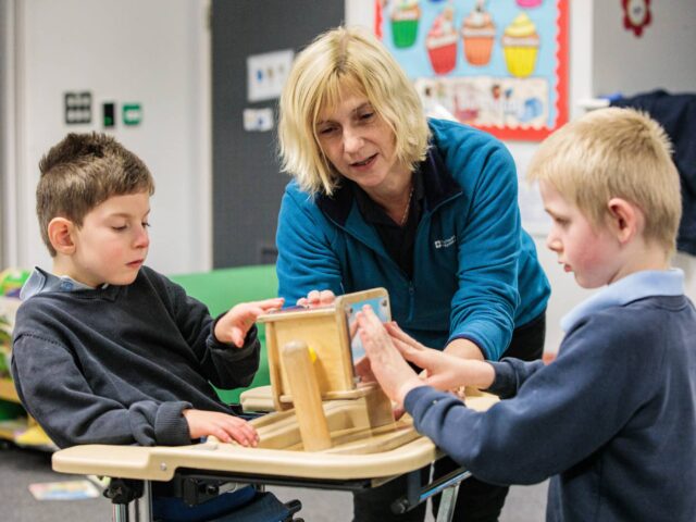 Teacher working with 2 children