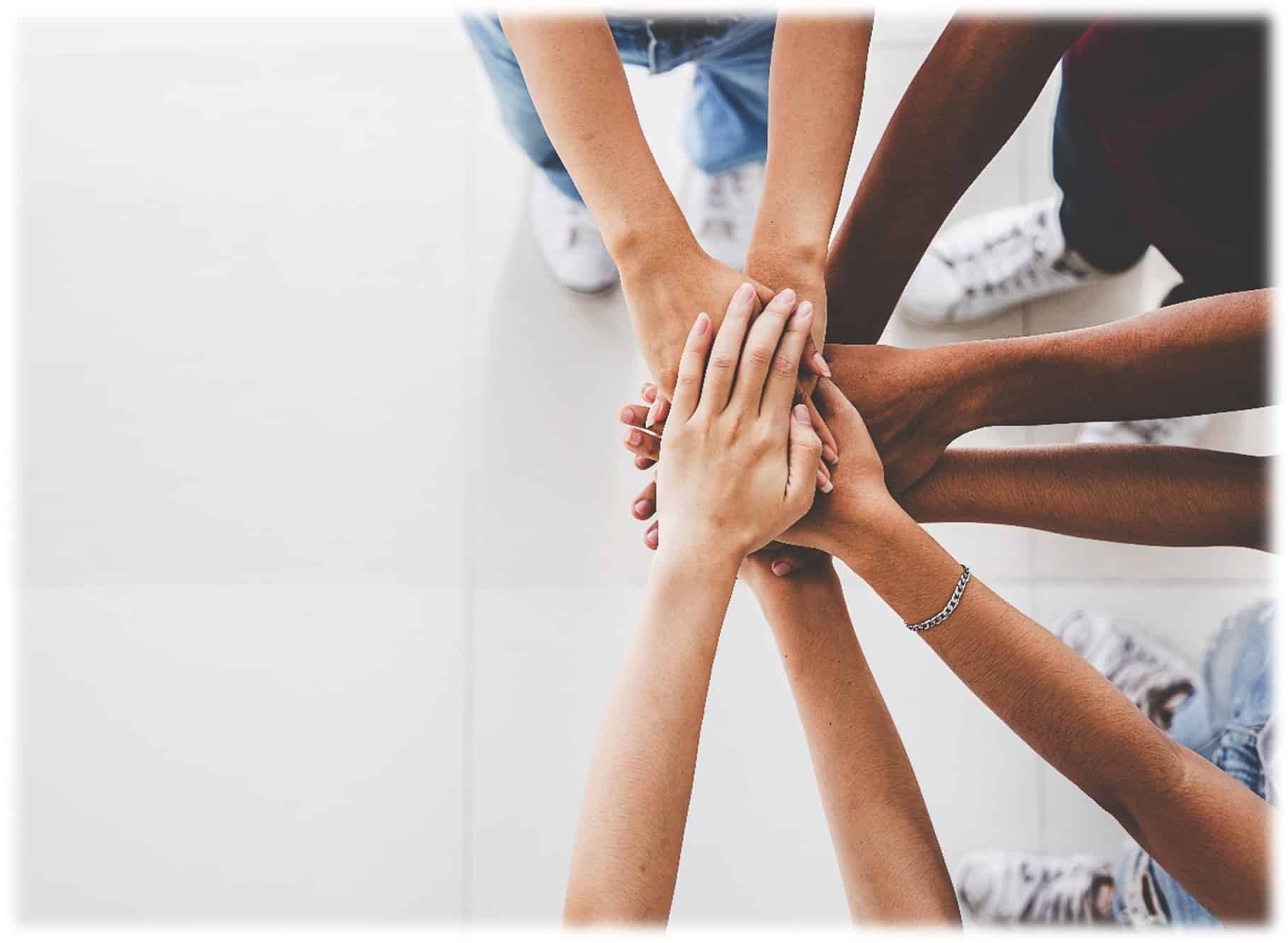 Children of different ethnicities putting hands together