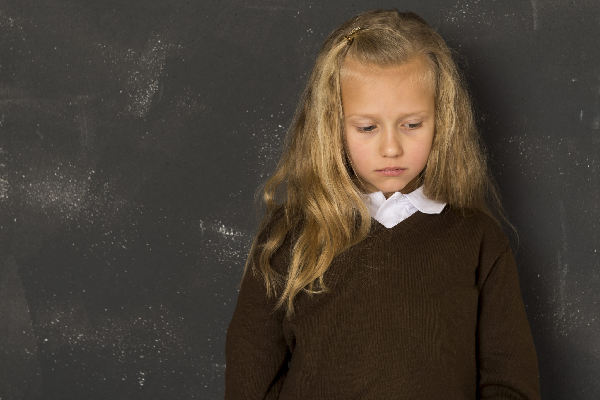 Young school girl looking sad