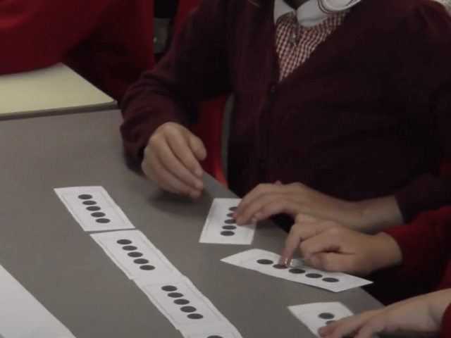 Primary aged pupils in a maths lesson.