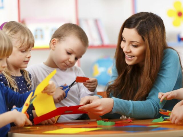 An early years teacher in a classroom with young children