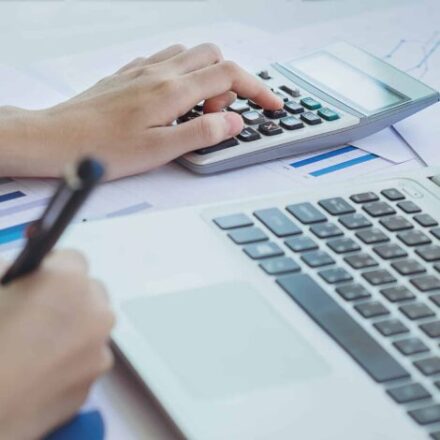 Working at a computer and with calculator