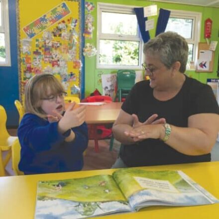 woman signing with child