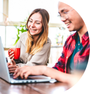 two young people working at their laptops