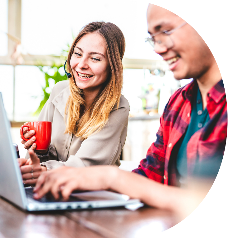 two young people working at their laptops