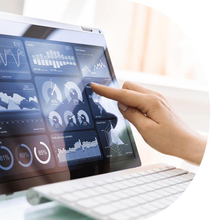 Picture of a laptop showing a dashboard with graphs and information and a hand touching a graph on the screen.